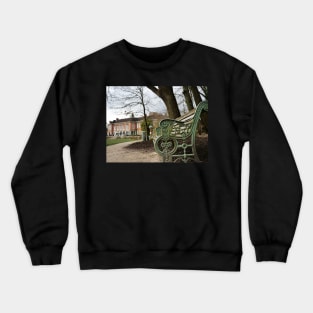 A bench in the park with a background of  South Hill Park Arts Centre, Bracknell, England, UK Crewneck Sweatshirt